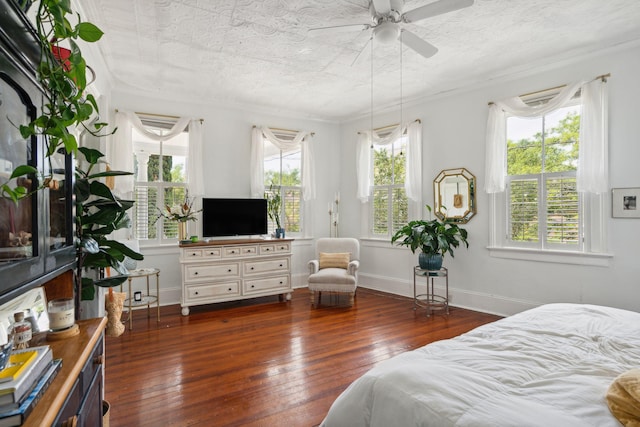 bedroom featuring a textured ceiling, ceiling fan, dark hardwood / wood-style flooring, and crown molding