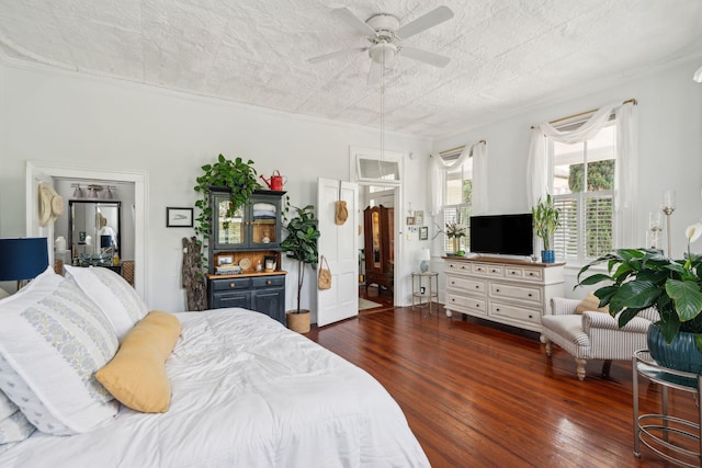 bedroom featuring dark hardwood / wood-style floors, ceiling fan, and crown molding