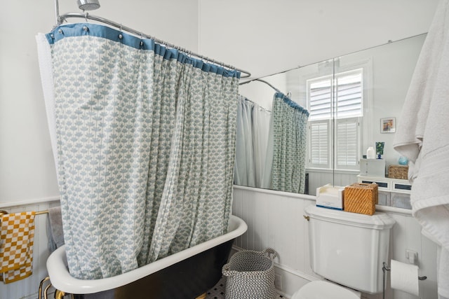 bathroom with toilet and shower / bath combo with shower curtain