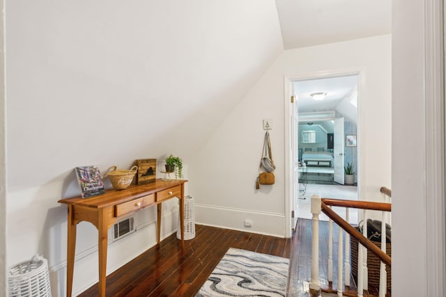 interior space featuring dark hardwood / wood-style floors and vaulted ceiling