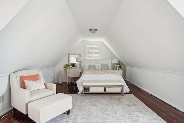 bedroom with lofted ceiling and dark hardwood / wood-style floors