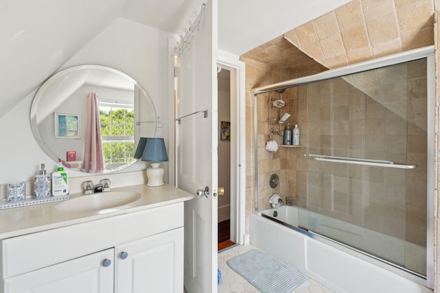 bathroom with tile patterned flooring, vanity, vaulted ceiling, and combined bath / shower with glass door