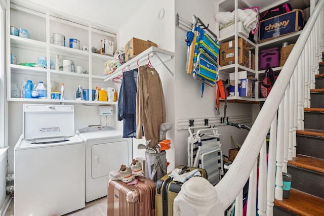 laundry room with light tile patterned floors and washing machine and clothes dryer