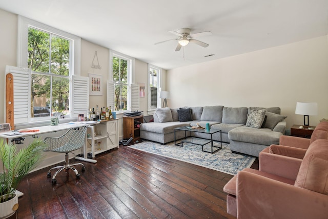 living room featuring ceiling fan, dark hardwood / wood-style flooring, and a healthy amount of sunlight