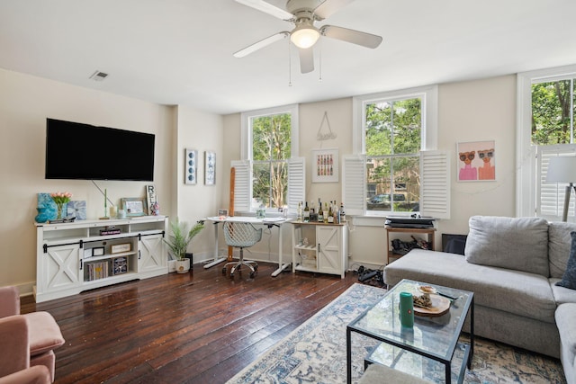 living room with ceiling fan and dark wood-type flooring