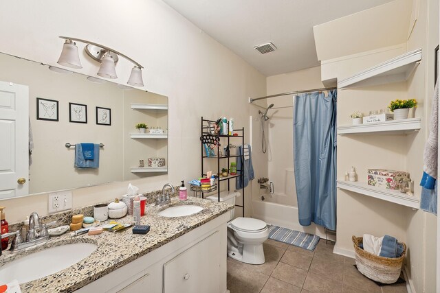 full bathroom featuring tile patterned flooring, vanity, toilet, and shower / bath combo with shower curtain