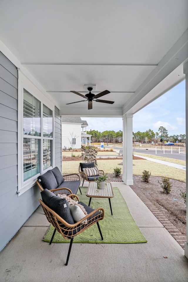 view of patio with ceiling fan and a porch