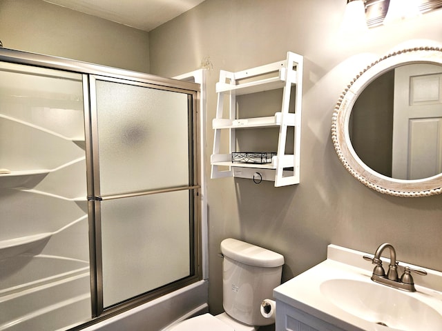 bathroom featuring vanity, toilet, and bath / shower combo with glass door