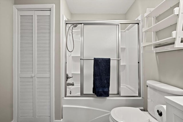 full bathroom with enclosed tub / shower combo, a closet, vanity, and toilet