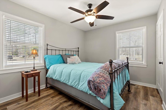 bedroom featuring ceiling fan, dark wood-style flooring, and baseboards