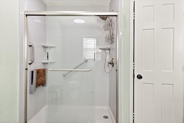 bathroom featuring a shower stall