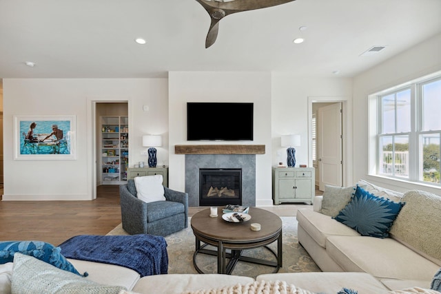 living room featuring wood-type flooring and a premium fireplace