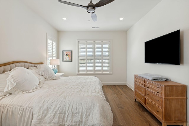 bedroom with dark wood-type flooring, ceiling fan, and multiple windows