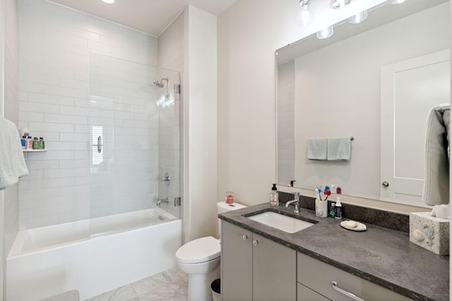 full bathroom with tile patterned floors, tiled shower / bath, toilet, and vanity