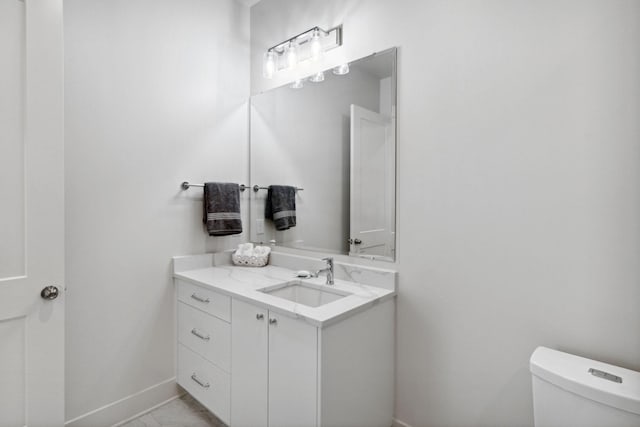 bathroom featuring vanity, toilet, and tile patterned floors