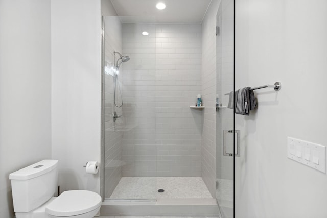 bathroom with toilet and walk in shower