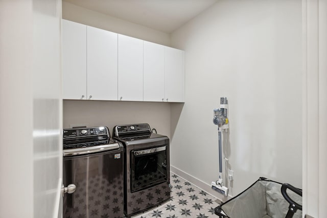 washroom featuring separate washer and dryer, cabinets, and light tile patterned floors