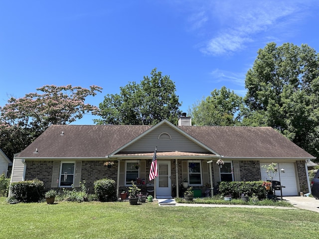 ranch-style house featuring a front lawn and a garage