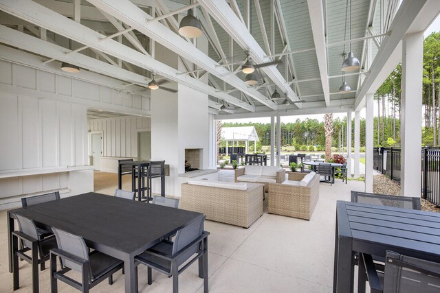 view of patio with ceiling fan and a bar