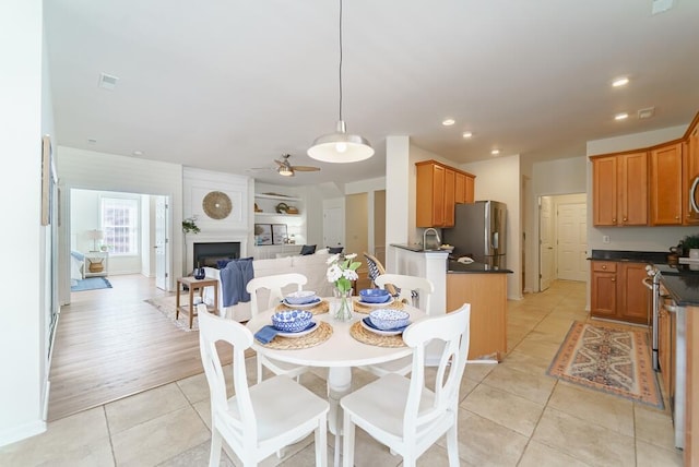 dining space featuring a fireplace, light tile patterned floors, recessed lighting, visible vents, and a ceiling fan