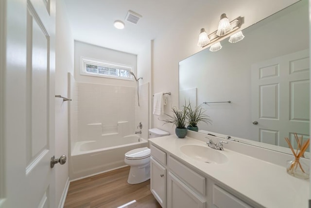 full bath with shower / bath combination, visible vents, toilet, vanity, and wood finished floors