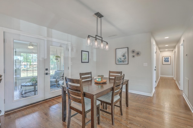 dining room with french doors and hardwood / wood-style flooring