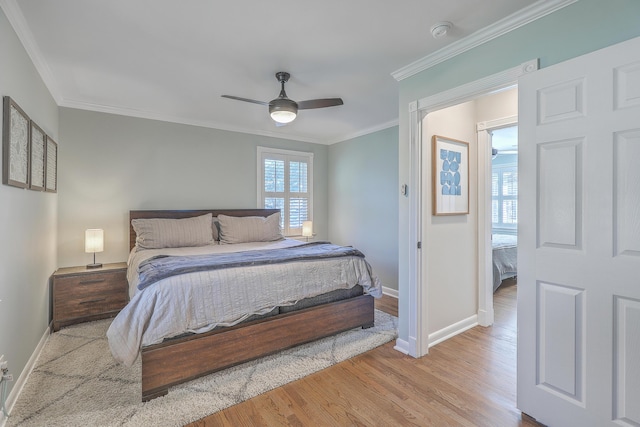 bedroom with ceiling fan, ornamental molding, and light hardwood / wood-style flooring