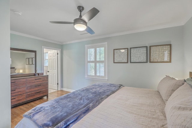 bedroom with ceiling fan, ornamental molding, and light wood-type flooring