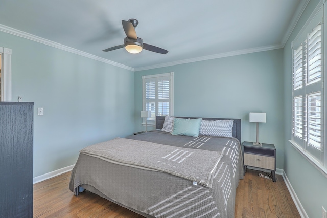 bedroom featuring hardwood / wood-style flooring, ceiling fan, and ornamental molding