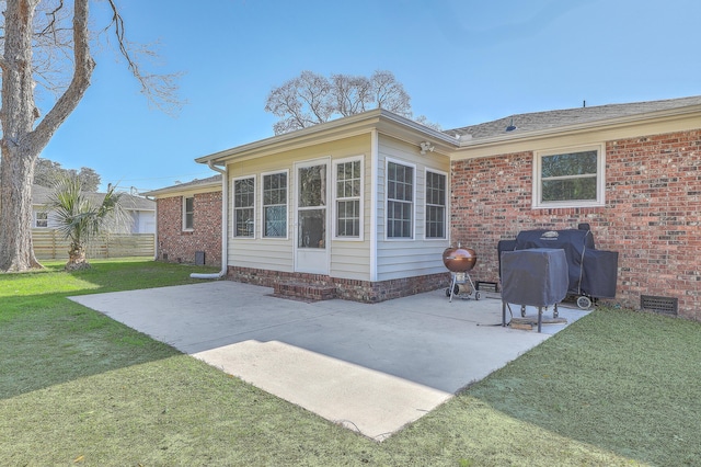 back of house featuring a lawn and a patio area