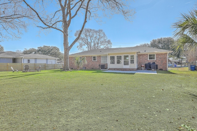 back of property featuring cooling unit and a lawn