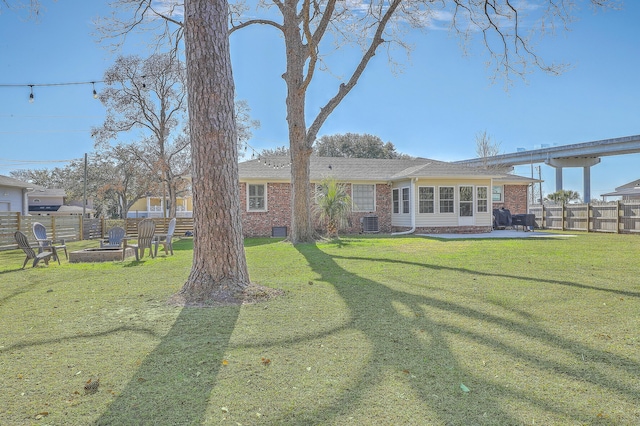 back of property with a yard and a patio area