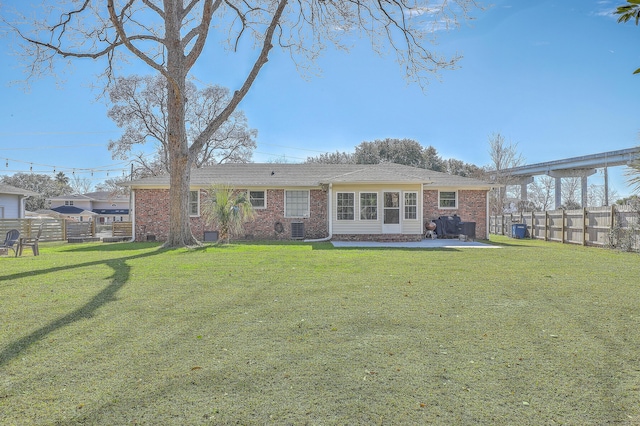 back of property with a patio and a lawn