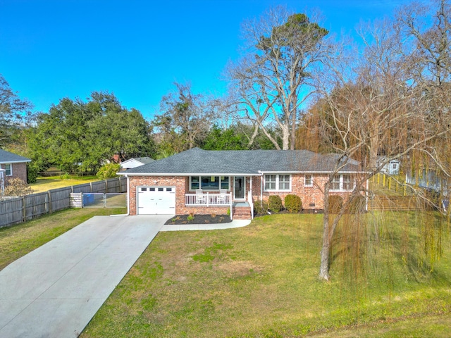 ranch-style house featuring a front yard, a porch, and a garage