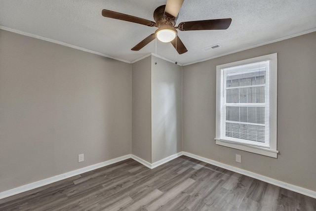 empty room with hardwood / wood-style flooring, crown molding, ceiling fan, and a textured ceiling