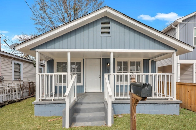 rear view of house with covered porch