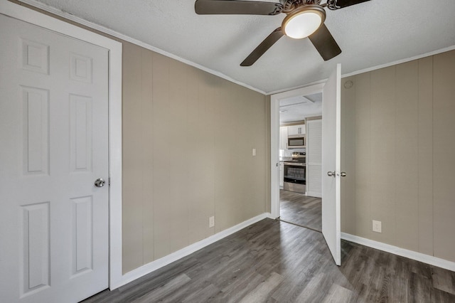 unfurnished bedroom with a textured ceiling, wood-type flooring, ornamental molding, and ceiling fan