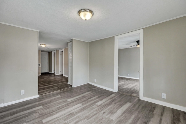 spare room with ceiling fan, wood-type flooring, ornamental molding, and a textured ceiling