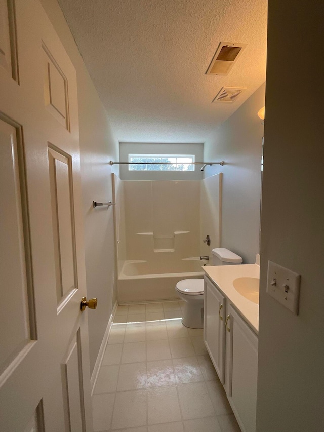 full bathroom with a textured ceiling, tile patterned floors, shower / bathing tub combination, vanity, and toilet