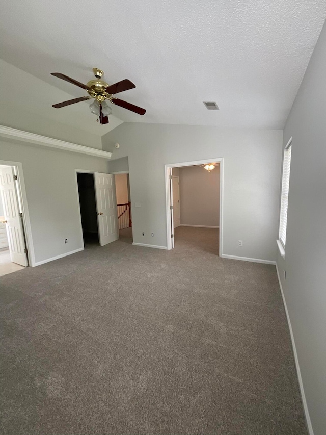 spare room featuring ceiling fan, a textured ceiling, lofted ceiling, and carpet floors