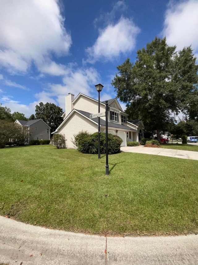 view of side of home with a yard and a garage