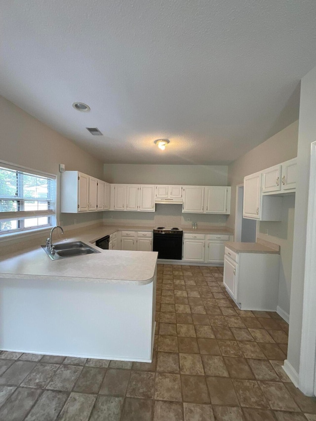 kitchen featuring a textured ceiling, black range with electric cooktop, sink, and white cabinetry