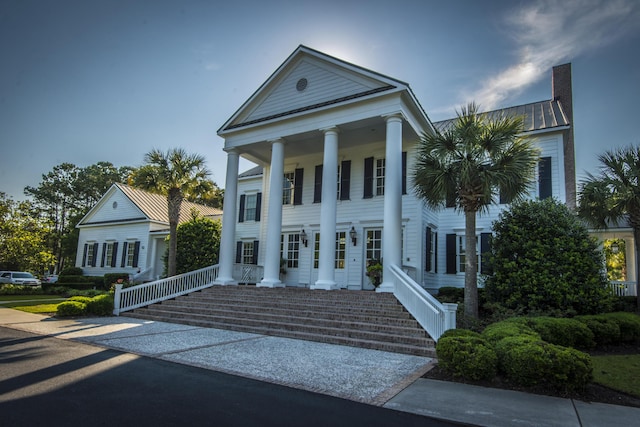 3000 Treadwell St, Mount Pleasant, SC 29466 - greek revival house featuring covered porch, metal roof, a standing seam roof, and a chimney