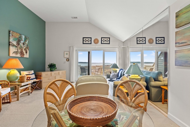 dining space with baseboards, visible vents, high vaulted ceiling, and carpet