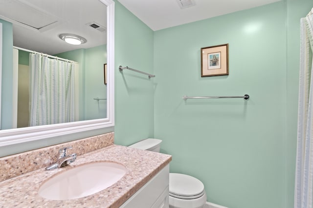 bathroom with visible vents, toilet, vanity, and a shower with curtain