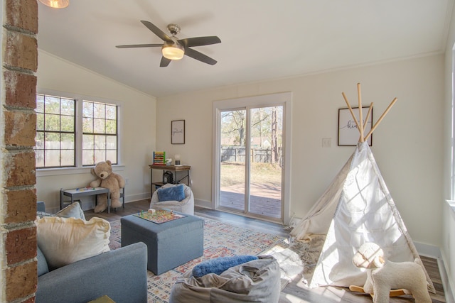 living room featuring lofted ceiling, wood finished floors, a wealth of natural light, and baseboards