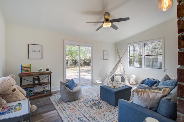 living area with ceiling fan, baseboards, vaulted ceiling, and dark wood-type flooring