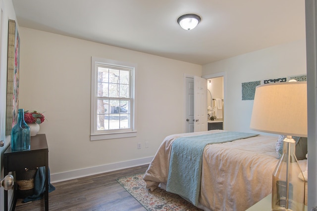 bedroom with wood finished floors and baseboards