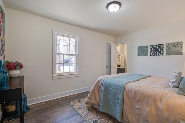 bedroom with wood finished floors and baseboards