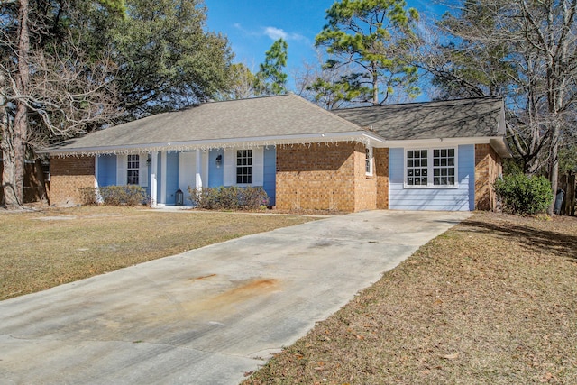 ranch-style house with concrete driveway, brick siding, a front yard, and a shingled roof